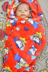 Portrait of cute baby lying on carpet