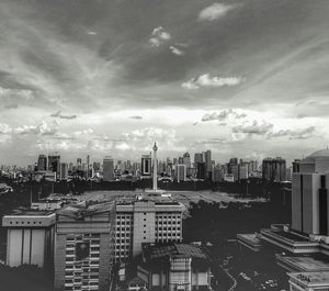 Skyscrapers against cloudy sky