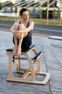 Side view of woman exercising on street