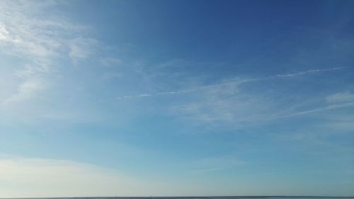Low angle view of vapor trail in blue sky