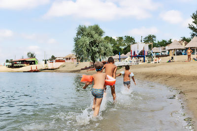 People on beach against sky