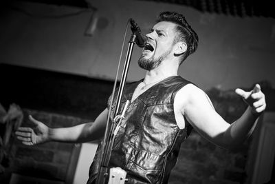 Midsection of young woman playing guitar
