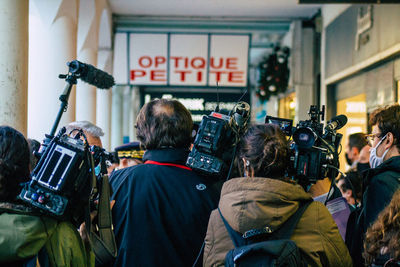 Rear view of people on street in city