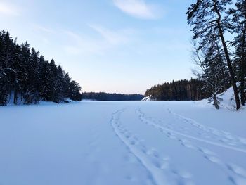 Snow covered landscape against sky