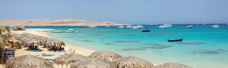 Panoramic view of beach against clear sky