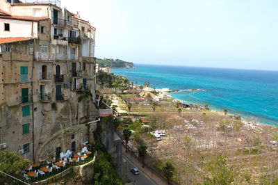 High angle view of beach by buildings against sky