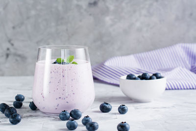 Smoothies with blueberries and mint in a glass on the table. antioxidant organic diet food