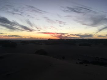 Scenic view of silhouette landscape against sky during sunset