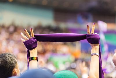 Close-up of hand holding ice cream cone at music concert