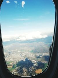 Aerial view of landscape seen through airplane window