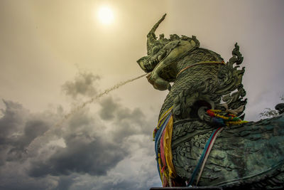 Low angle view of statue against sky
