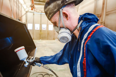 Side view of man working in workshop