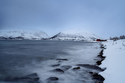 Scenic view of snowcapped mountains against clear sky