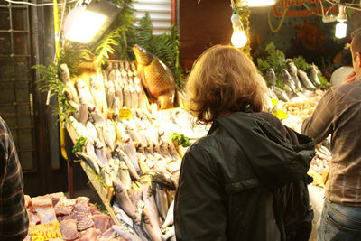 Rear view of man standing on tiled floor