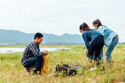 Friends sitting on land