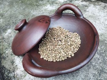 Green coffee beans in a clay pot for roasting