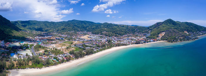 Panoramic view of sea and mountains against sky