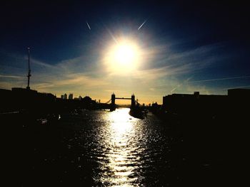 Silhouette city against sky during sunset