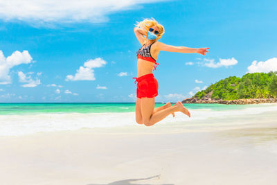 Woman on beach against sky