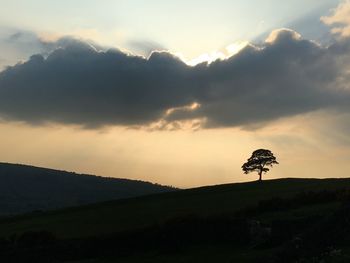 Silhouette landscape against sky during sunset