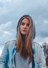 Portrait of beautiful woman against sky