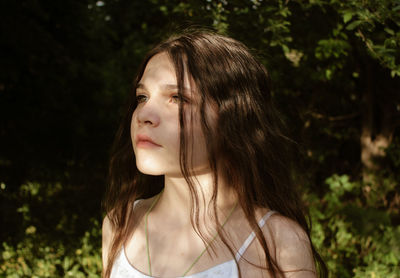 Portrait of beautiful young woman looking away