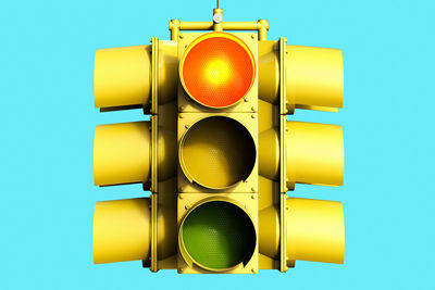 Low angle view of road signal against blue sky