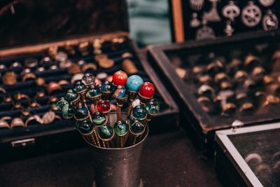 High angle view of colorful marbles in container on table