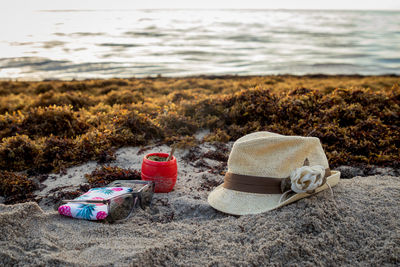 Mate,  hat, sunglasses in the beach at sunrise