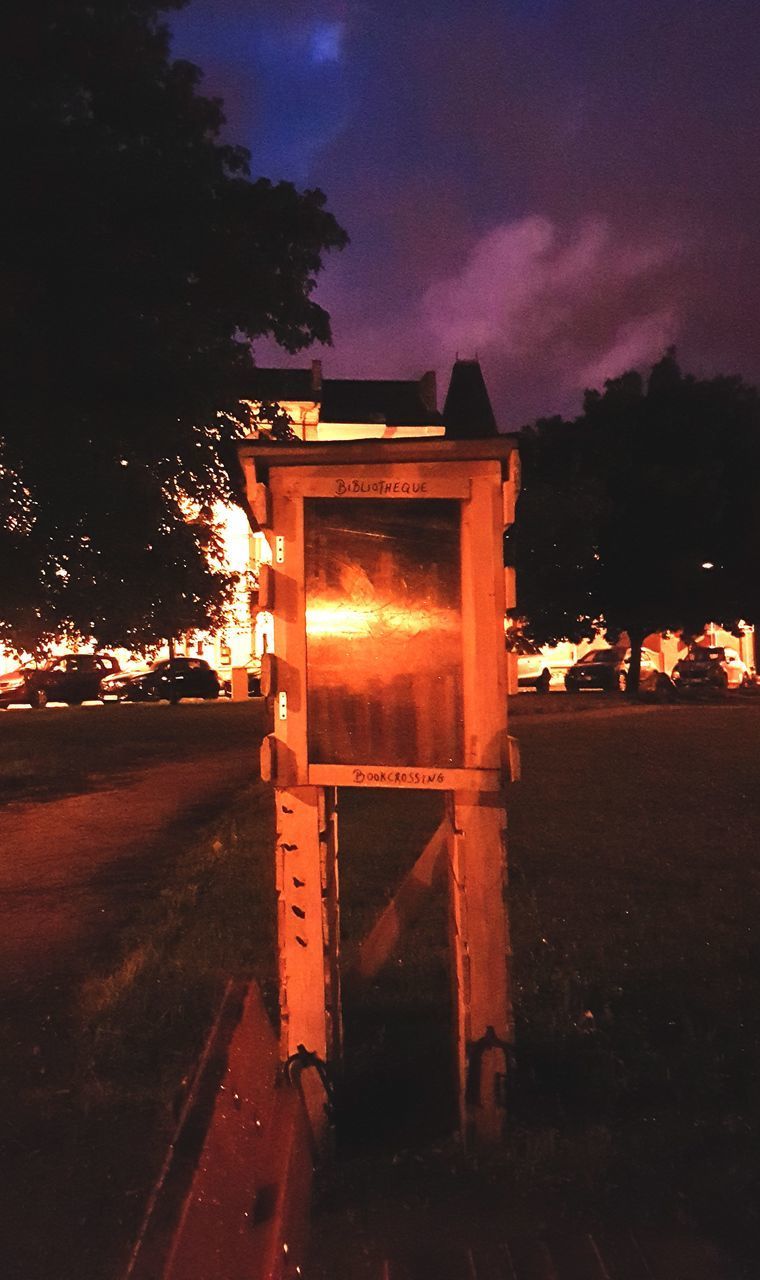 CLOSE-UP OF ILLUMINATED BUILDING AT SUNSET