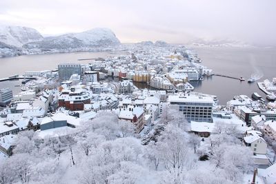 High angle view of townscape by snow covered city