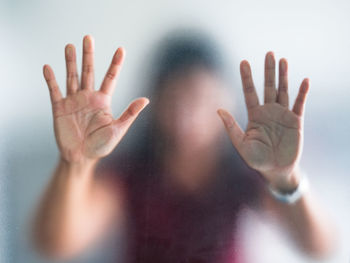 Close-up of hand on glass