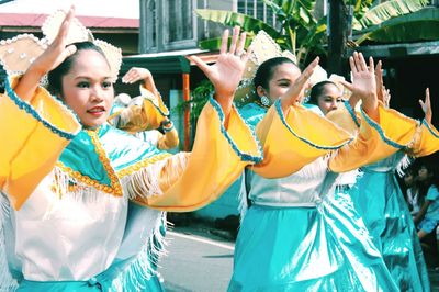 Women standing in traditional clothing during festival