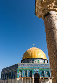 Low angle view of building against clear blue sky