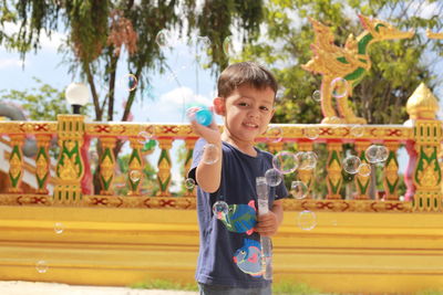 Portrait of cute boy standing outdoors