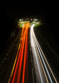 High angle view of light trails on highway at night