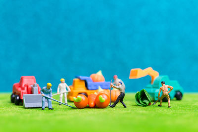 Close-up of figurines against blue background