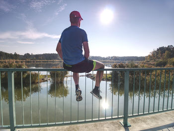 Full length of man by lake against sky