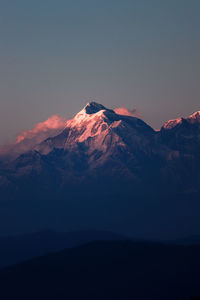 Scenic view of snowcapped mountains against sky during sunset