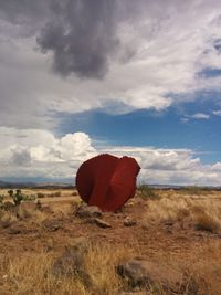 Scenic view of red land against sky
