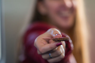 Close-up of woman holding cookie