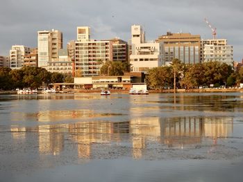Reflection of trees and buildings in lake