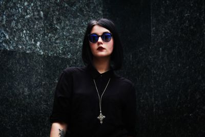 Portrait of goth young woman wearing sunglasses