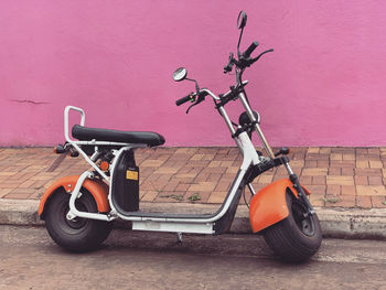 Motor scooter against wall 