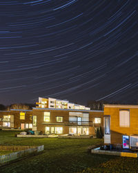 Illuminated buildings with star trails