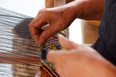 Midsection of person weaving