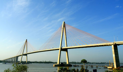 Low angle view of suspension bridge over river