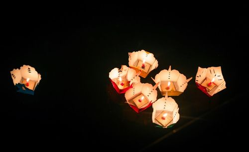 Close-up of illuminated lighting equipment against black background