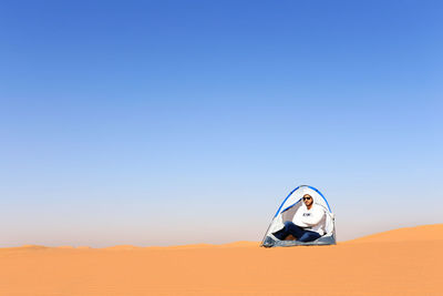 Woman wearing sunglasses against clear sky