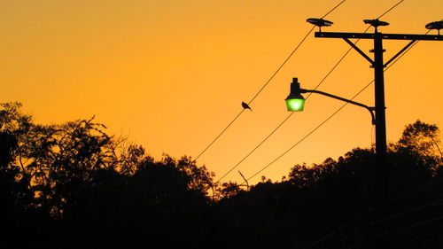 Low angle view of silhouette trees against sky during sunset